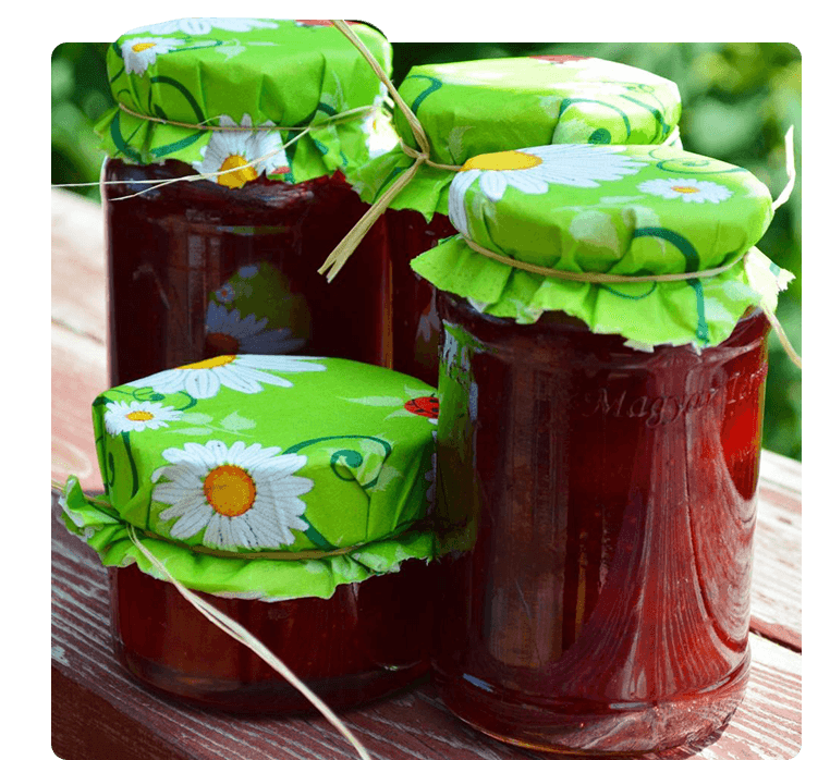 A group of jars with lids on them sitting on top of a table.