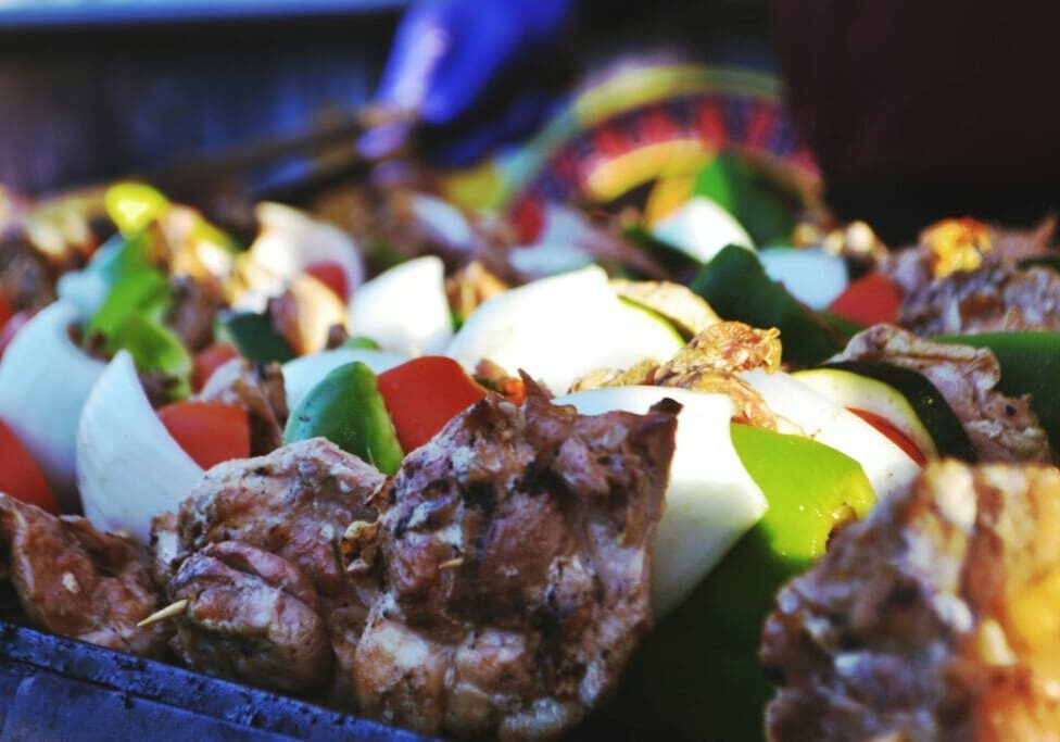 A close up of meat and vegetables on the grill